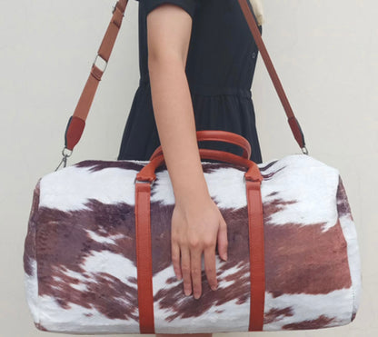 Faux fur cow print duffel bag